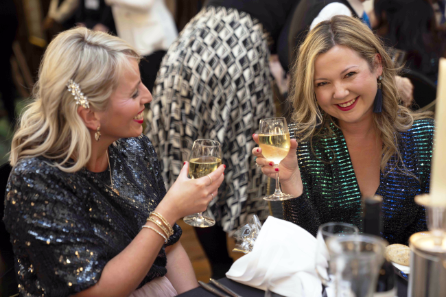 Two people smiling with drinks